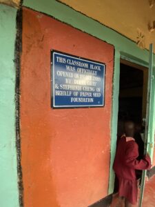 a Kenyan girl entering a classroom